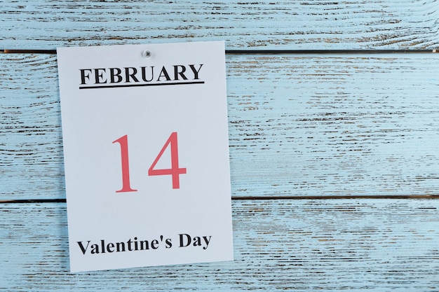 Valentines Day, February 14 on calendar on wooden background