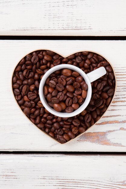 Valentines day  from coffee beans. Heart shape form and cup.