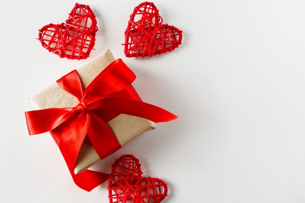 Valentines day gift and red hearts on a white background