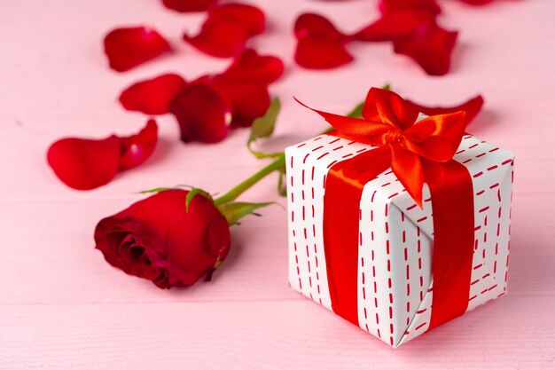 Valentines day gift and rose on wooden table