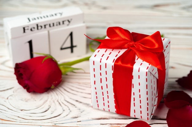 Valentines day gift and rose on wooden table