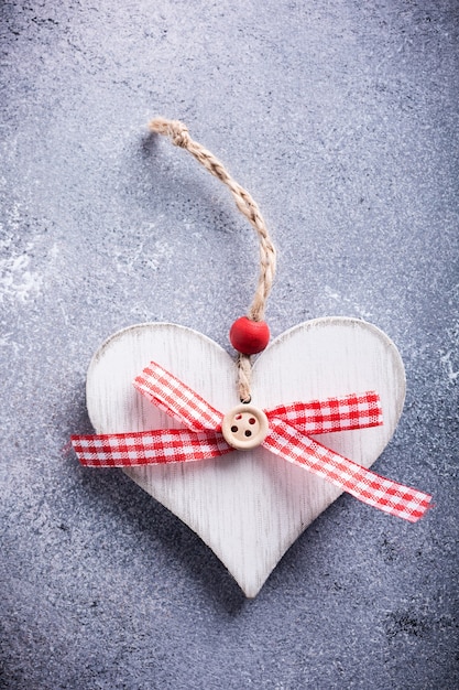 Valentines Day greeting card with decorative wooden heart on concrete stone with copy space for text. Valentine's Day concept. View from above