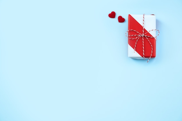 valentines day handmade wrapped gift box on blue background