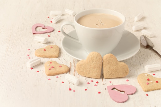 Valentines day heart shaped cookies and cup of coffee