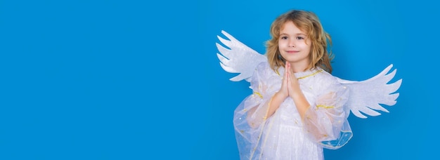 Valentines day little cupid angel child with wings with prayer hands hope and pray concept studio po