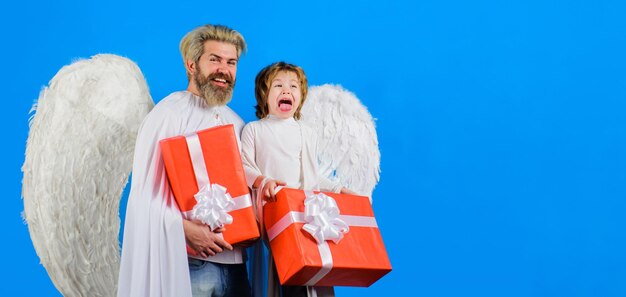 Valentines day little cupid boy and bearded man in angel wings with valentine gift father and son