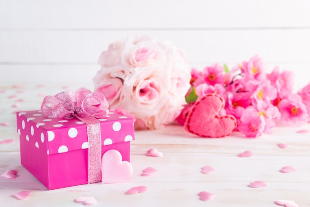 Valentines day and love concept. Pink gift box with heart and flowers