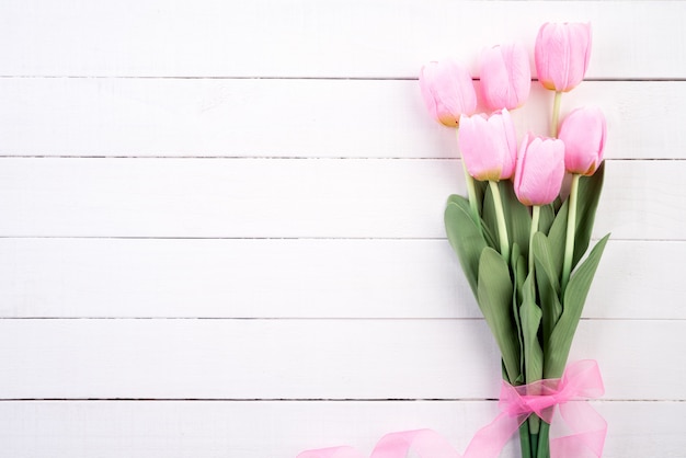 Valentines day and love concept. Pink tulips with pink ribbon