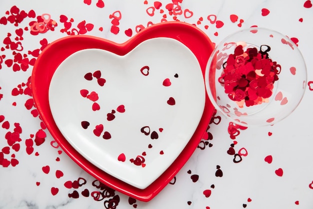 Valentines day red and white dinner plates with heart shaped confetti