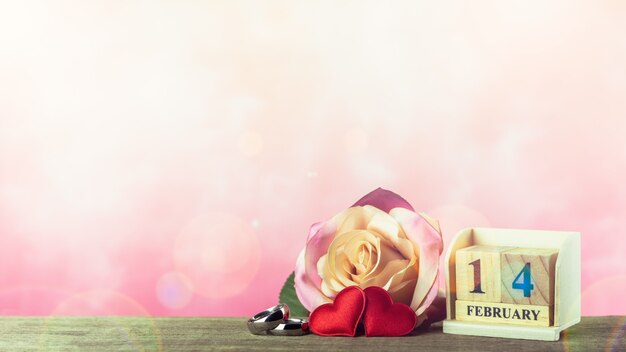 Valentines day theme with wooden block calendar and red hearts. - February 14.