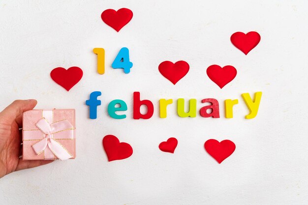 Photo valentines day a white background a gift box with the inscription february 14 top view