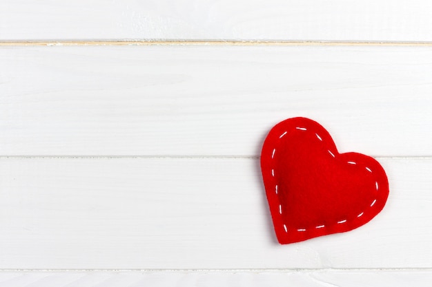 Photo valentines day with handmade toy hearts on wooden table