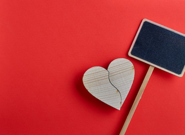 Valentines day wooden heart on red background