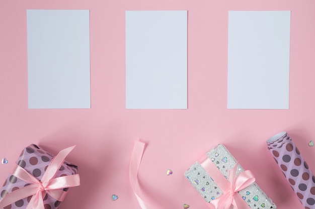 Valentines flat lay with gifts, ribbons and glitter hearts.