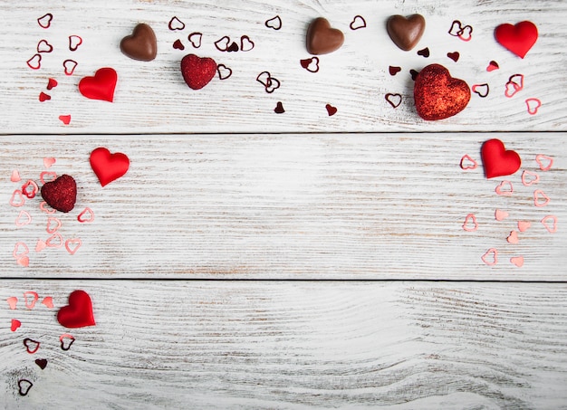 Valentines holiday, heart confetti on wooden floor 