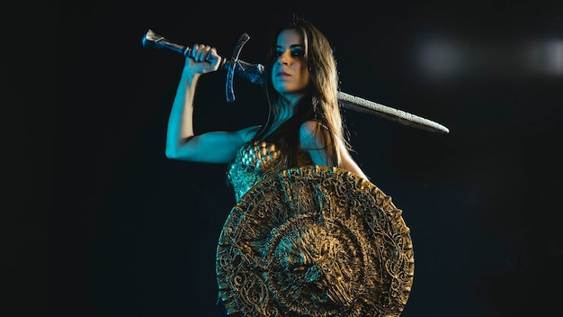 Photo valkyrie warrior, woman with golden armor iron coat and big warrior sword