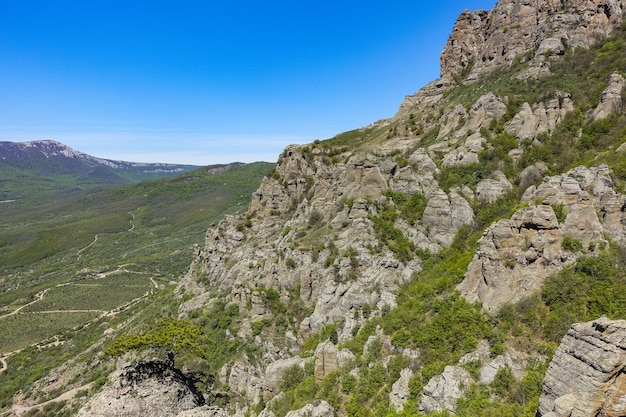 The Valley of Ghosts. Demerji. Green trees and bushes in the foreground. May 2021. Crimea.