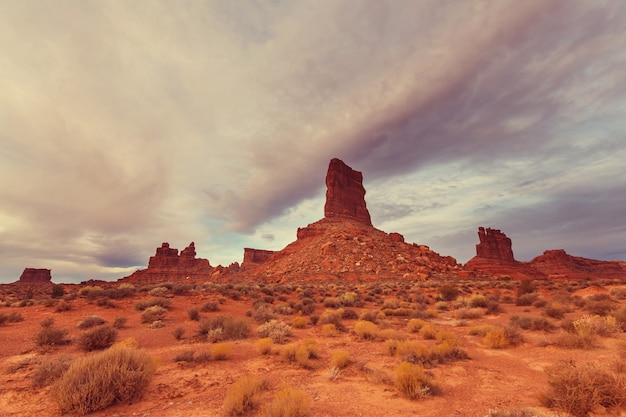 Valley of the Gods rock formation with Monument Valley at sunrise