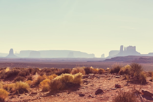 Valley of the Gods rock formation with Monument Valley at sunrise