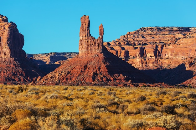 Valley of the Gods rock formation with Monument Valley at sunrise