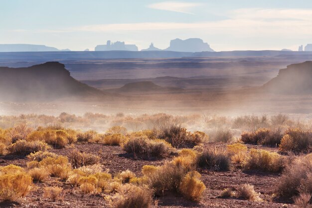 Valley of the Gods rock formation with Monument Valley at sunrise