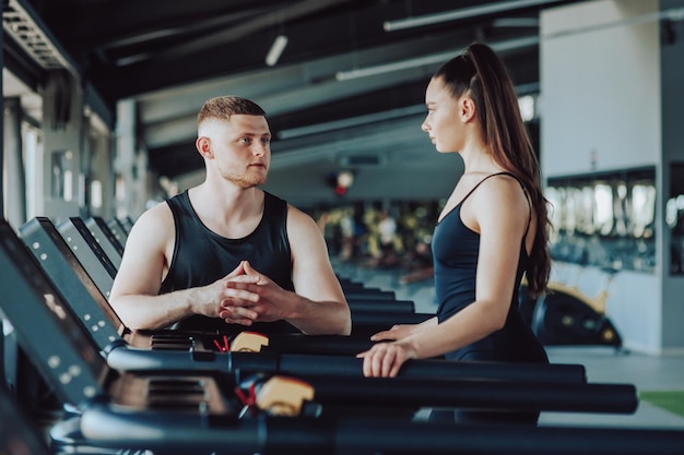 the valuable dialogue between a knowledgeable personal trainer and a female client as they discuss exercise routines fitness progress and the path to a healthier lifestyle