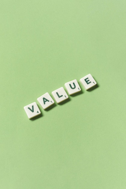 Value formed of scrabble blocks on green background