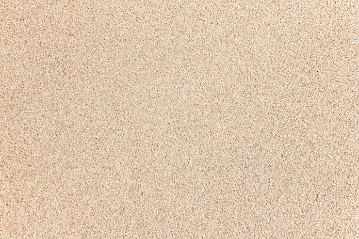 Foto van de overzeese de textuurachtergrond strandzand