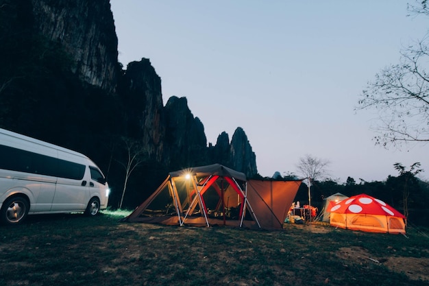 A van and tent in front of a mountain