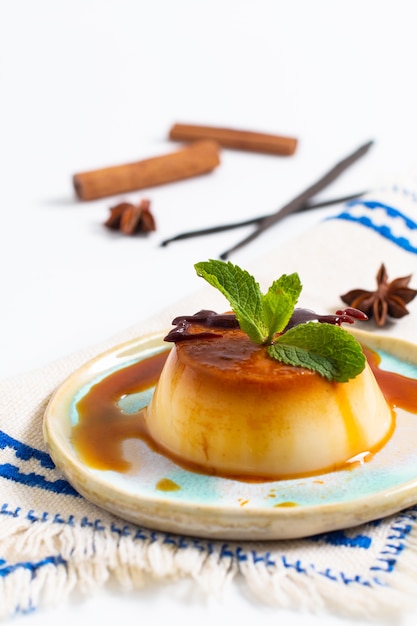 Vanilla Caramel custard or panna cotta with vanilla beans and spices on white background