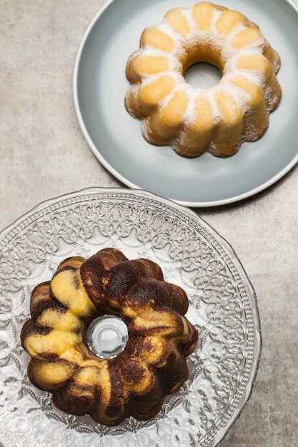 A vanilla and chocolate bundt cake and a lemon bundt cake in a top view