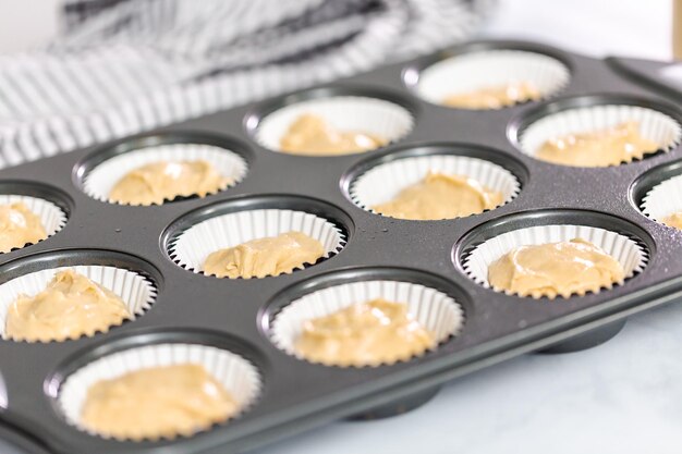 Vanilla cupcake batter in cupcake pan.