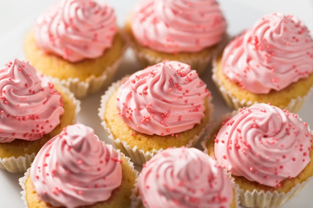 Vanilla cupcakes with pink cream