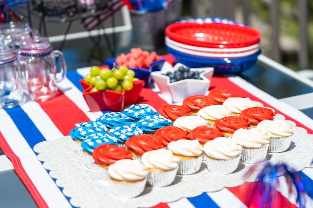 Vanilla cupcakes with red, blue, and white icing shaped in an American flag.