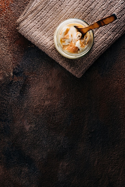 Vanilla custard with homemade cookie on wooden table. Top view. Copyspace