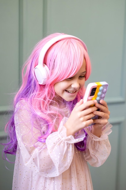 Vanilla Girl Kawaii vibes Little girl with pink hair have party in barbie style Listening music with headphones mobile phone