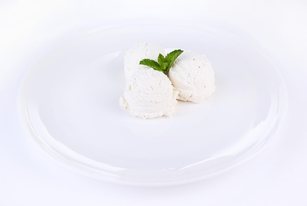 Vanilla ice cream balls on plate isolated on white