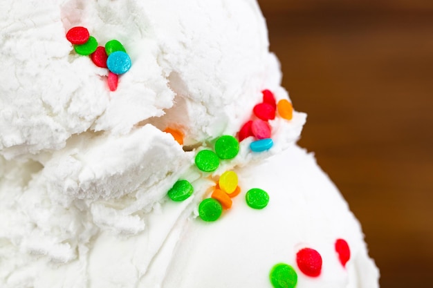 Vanilla ice cream scoop swith sprinkles, close up.