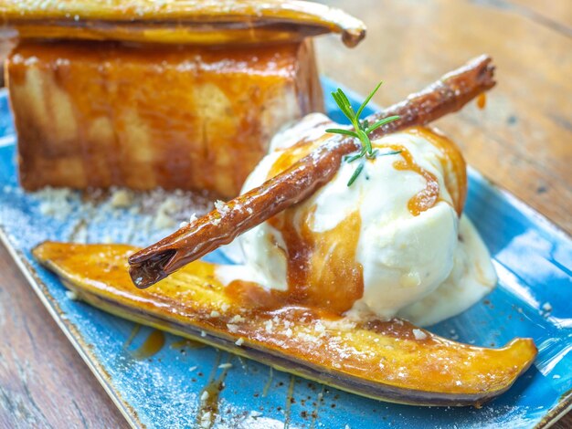 Vanilla Ice cream topping with caramel on ceramic plate Closeup Caramelized Banana Toast homemade dessert