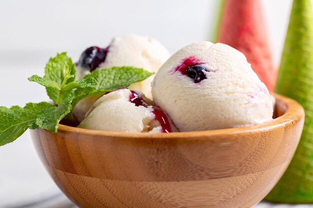 Vanilla ice cream with berry sauce close up