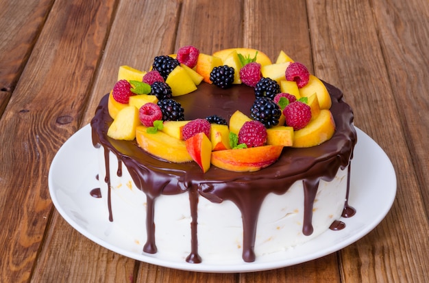 Vanilla mousse cake with peaches and chocolate glaze