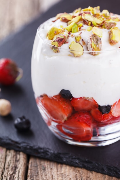 Vanilla mousse with strawberries, blueberries and pistachios 