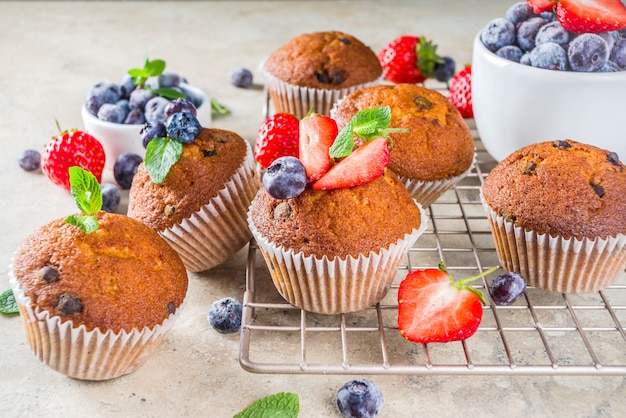 Vanilla muffins or cupcakes with berries