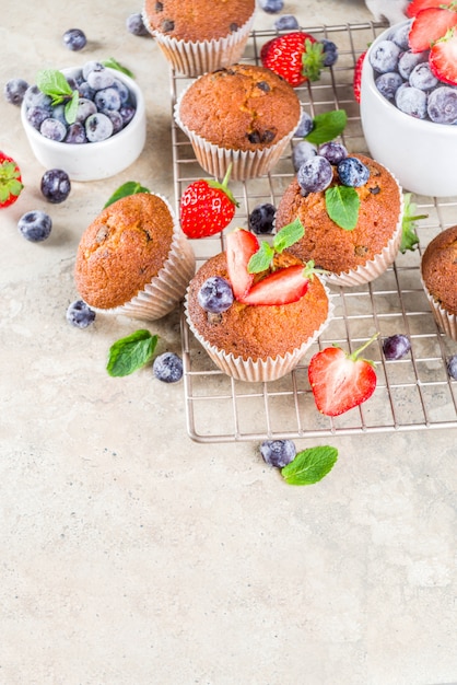 Vanilla muffins or cupcakes with berries