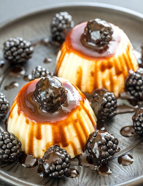 Vanilla puddings with fresh blackberries and berry topping