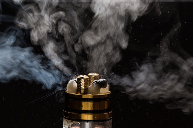 Vape close-up with smoke on a black background