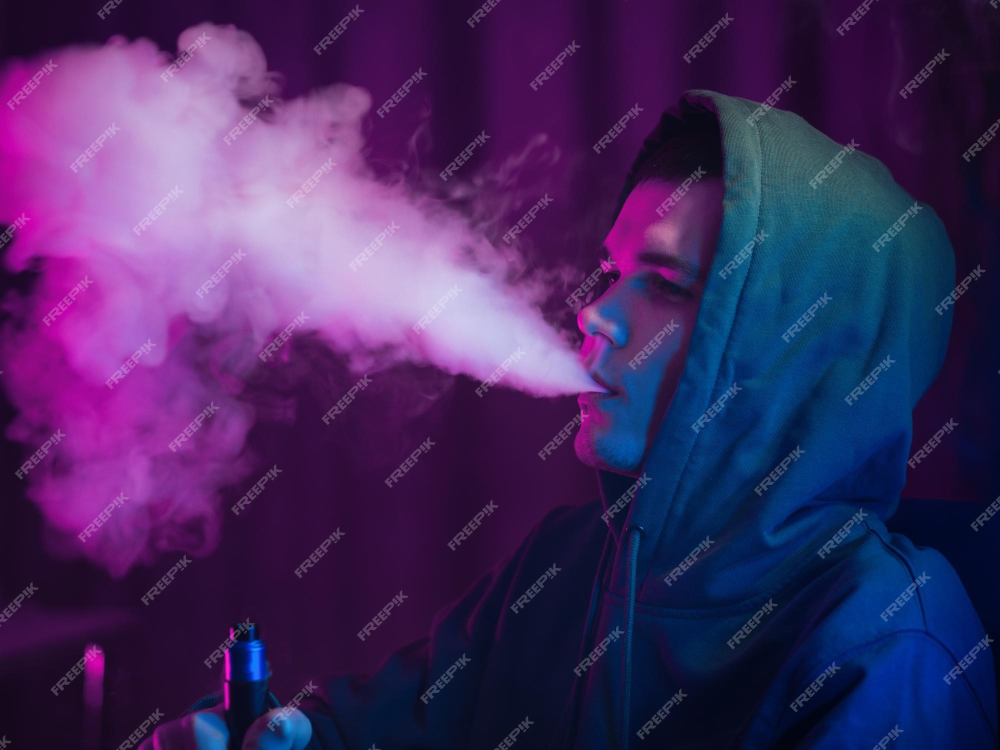 Premium Photo  Vape man exhales a cloud of steam neon light