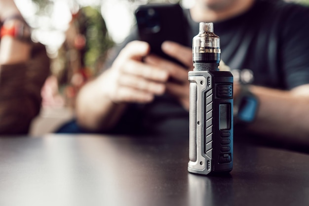 Vape stands on a wooden table in cafe