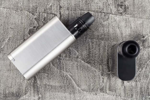 Vaping device on a concrete background.