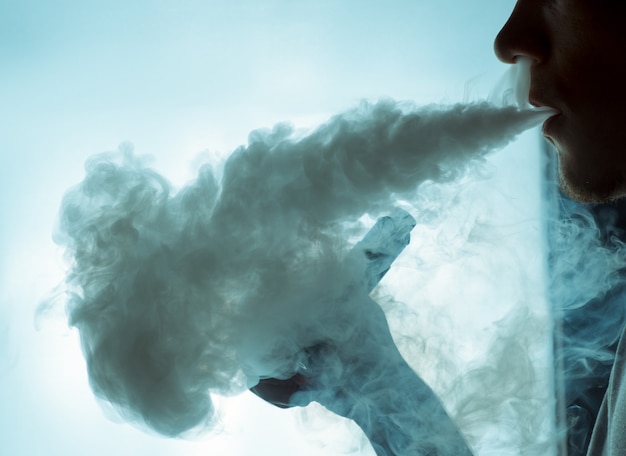 Vaping an electronic cigarette with a lot of smoke.